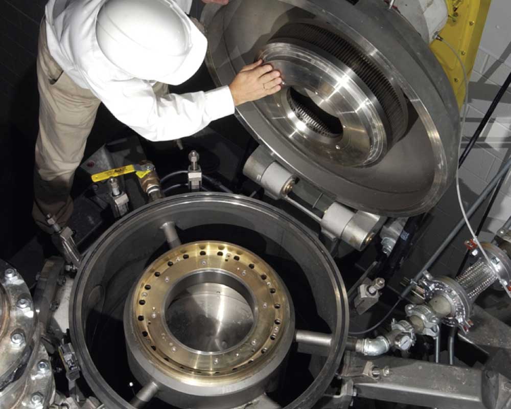Person inspecting a jaw crushing machine