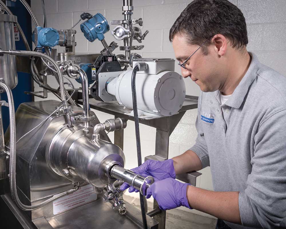 Person operating a wet media milling machine