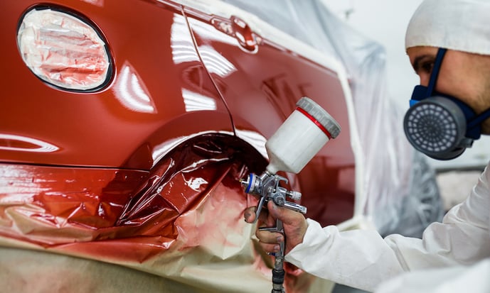 technician painting a car